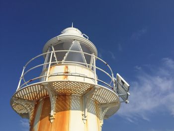 Low angle view of lighthouse against blue sky