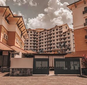 View of buildings against cloudy sky