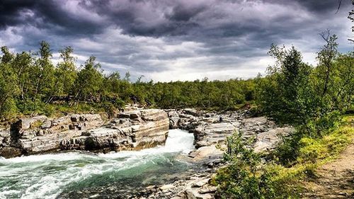 Scenic view of landscape against cloudy sky