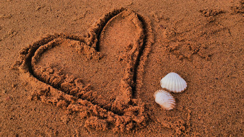 High angle view of heart shape on sand