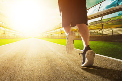 Low section of man running on road