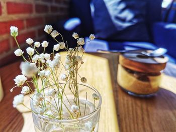 Midsection of man holding vase on table