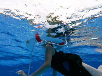 Low section of woman swimming in sea