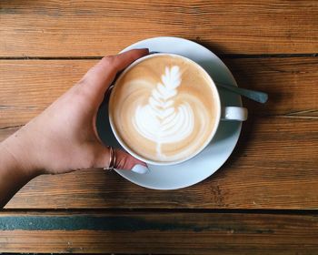 Cropped image of coffee cup on table