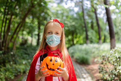 Portrait of smiling girl wearing costume standing at park