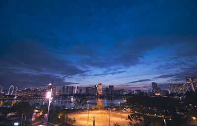 Illuminated cityscape against sky at night