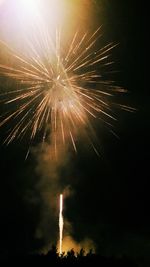 Low angle view of firework display at night