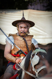 Portrait of man holding hat