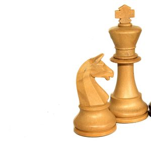 Close-up of chess pieces against white background