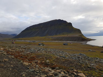 Scenic view of sea and mountains against sky