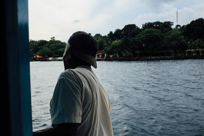 Rear view of man standing in water