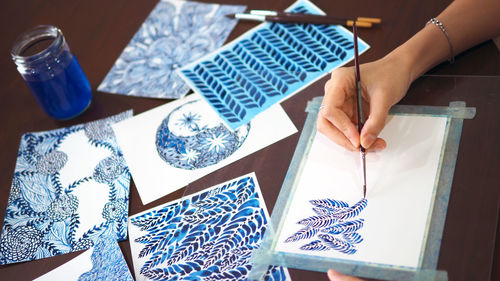 High angle view of woman painting on table