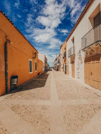 Empty alley amidst buildings in town