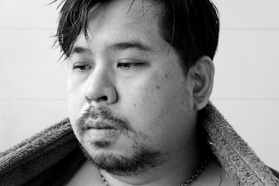 Close-up portrait of young man looking away