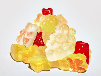 Close-up of multi colored candies against white background