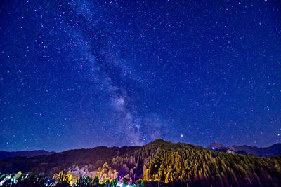 Scenic view of mountains against sky at night