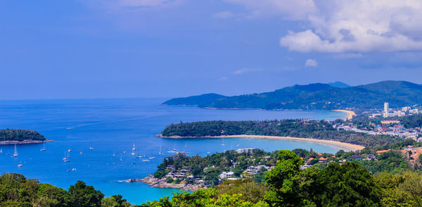 High angle view of sea and cityscape against sky