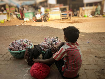 Rear view of people in basket at market