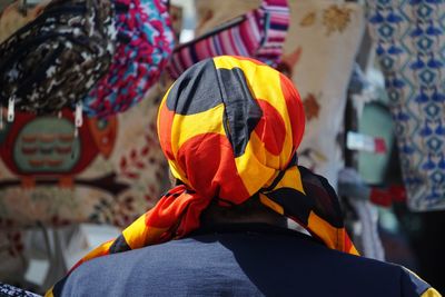 Rear view of man wearing colorful scarf