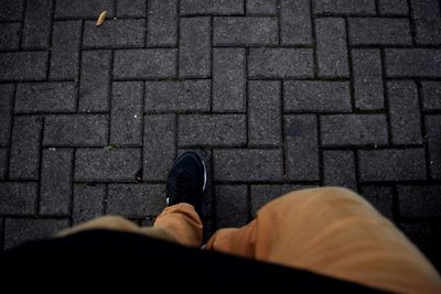 Low section of woman standing on tiled floor