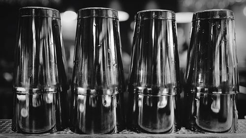 Close-up of shakers on shelf at bar