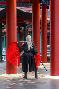 Rear view of woman standing in city