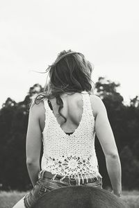 Girl standing against clear sky