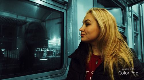 Woman looking through train window