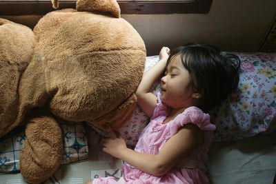 Close-up of girl sleeping on bed at home