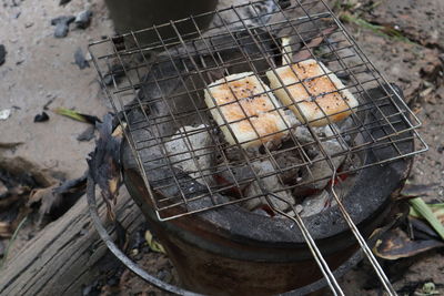 High angle view of meat on barbecue grill