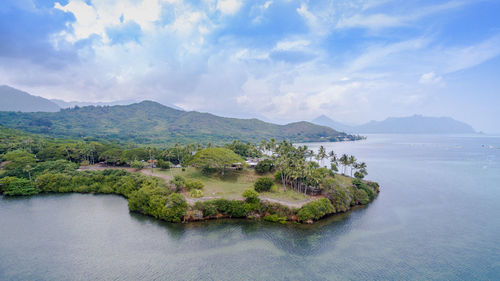 Scenic view of sea and mountains against sky