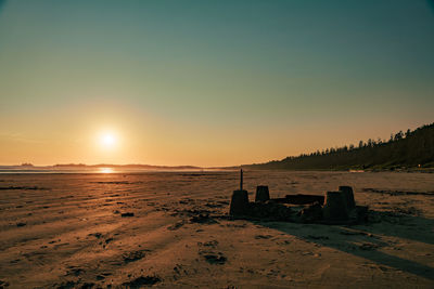 A sand castle at the beach during sunset