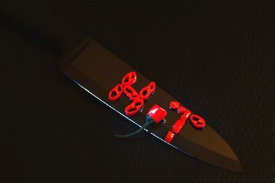 Close-up of illuminated information sign against black background