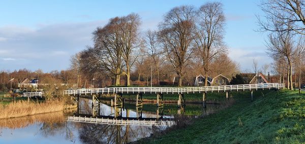 White bridge over canal reflecting on water 