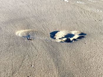 High angle view of text on sand