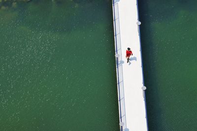 Full length of woman standing on railing