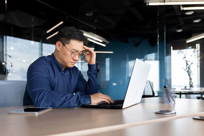 Young man using laptop at office