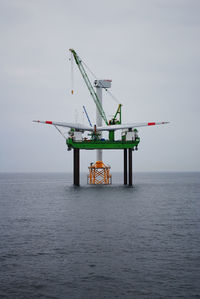 Lifeguard hut in sea against sky