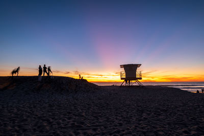 Scenic view of beach against sky during sunset