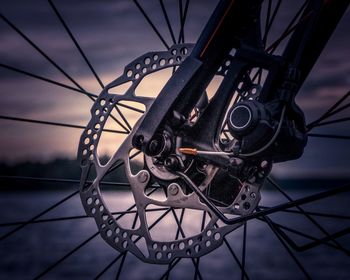 Close-up of bicycle wheel against sky