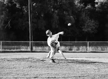 Boy playing baseball on playing field