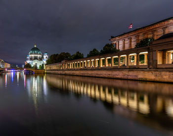 Reflection of illuminated building in water at night