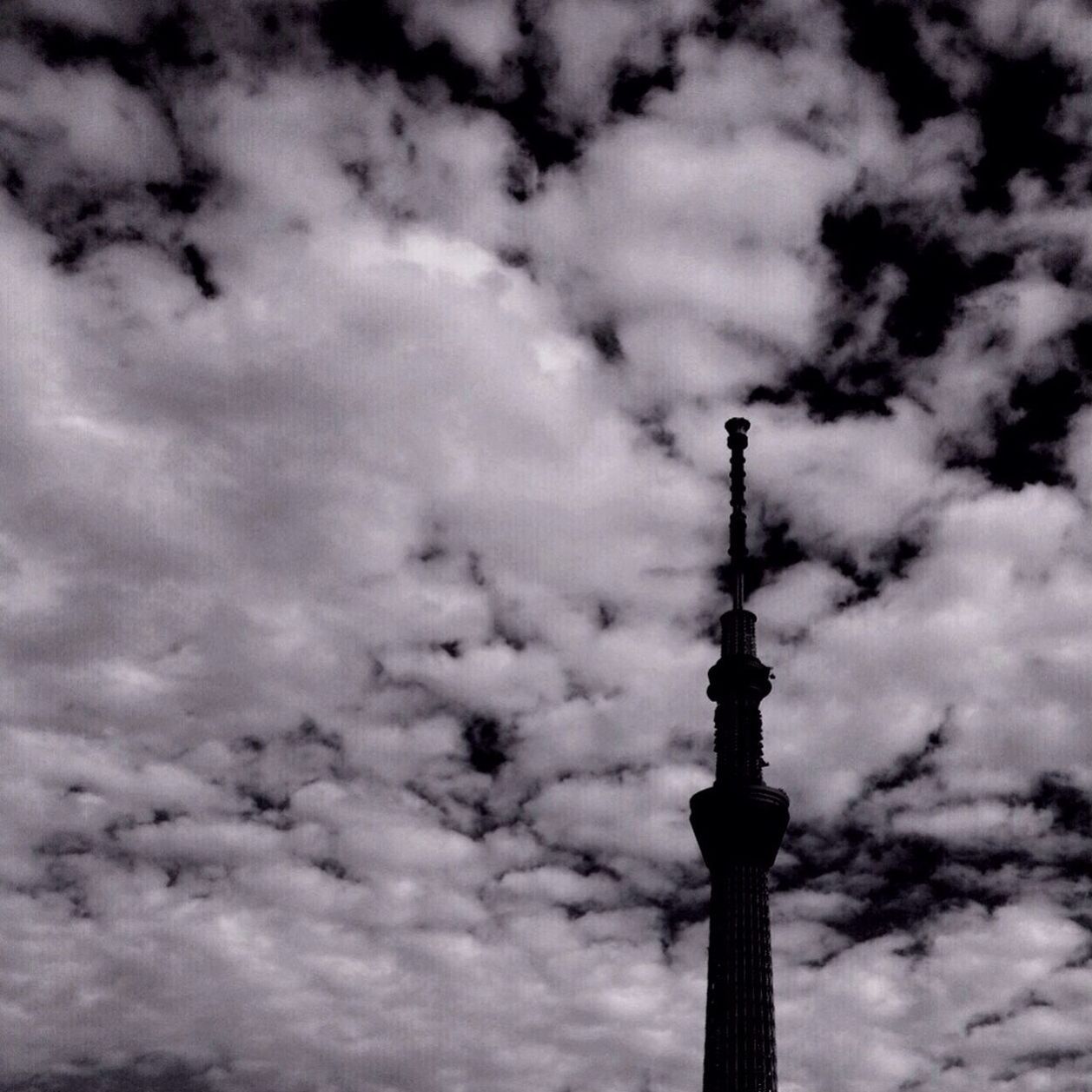 sky, low angle view, cloud - sky, cloudy, tower, built structure, architecture, communications tower, tall - high, communication, building exterior, cloud, travel destinations, famous place, international landmark, television tower, spire, weather, capital cities, tourism