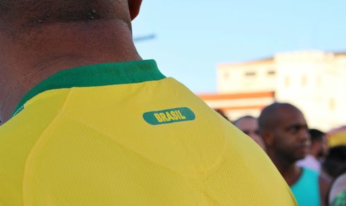 Close-up rear view of yellow men against the sky