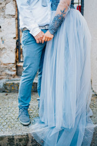 Low section of couple standing outdoors