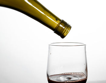 Close-up of glass bottle against white background