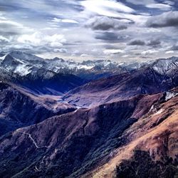 Scenic view of snow covered mountains against sky