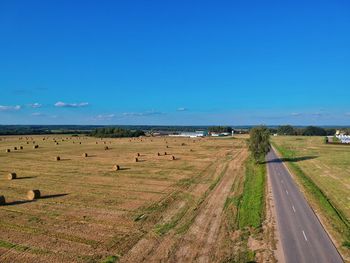 Scenic view of landscape against blue sky