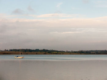 Sailboat on sea against sky