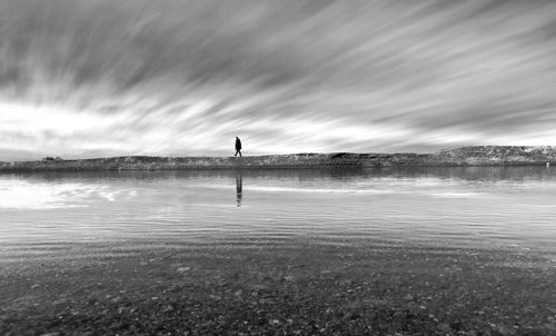 Man standing on beach against sky